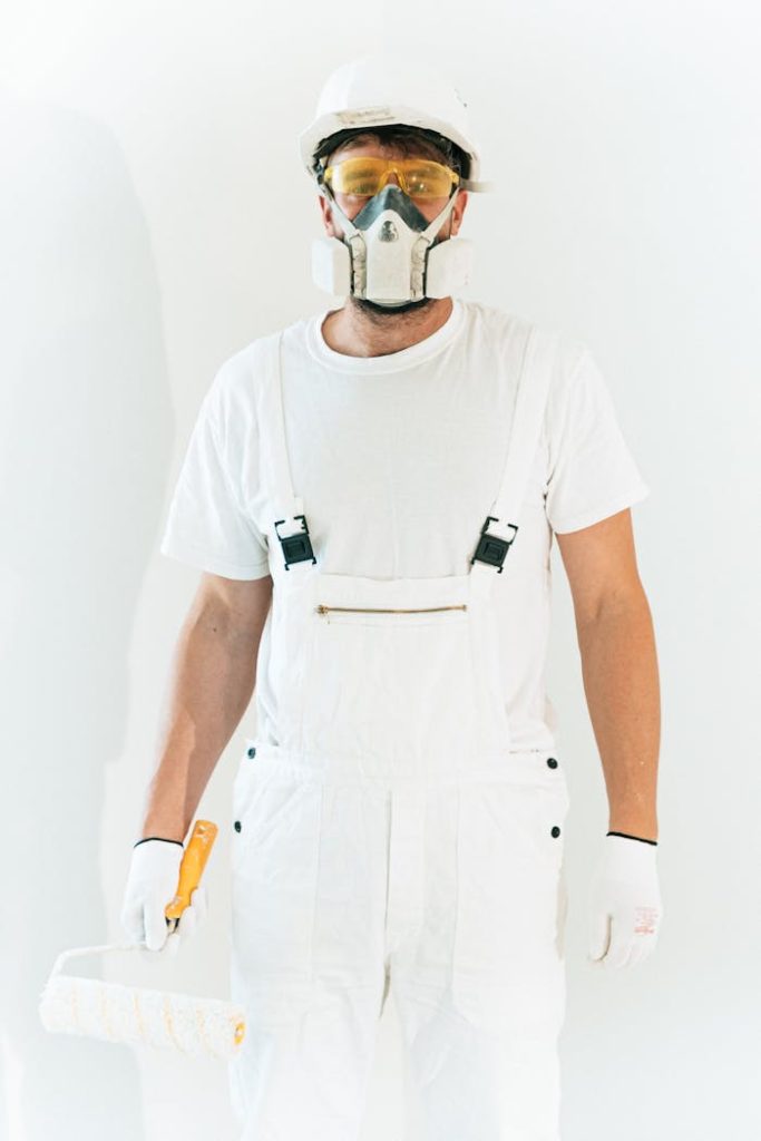 A Man Wearing Safety Glasses and Respirator Mask